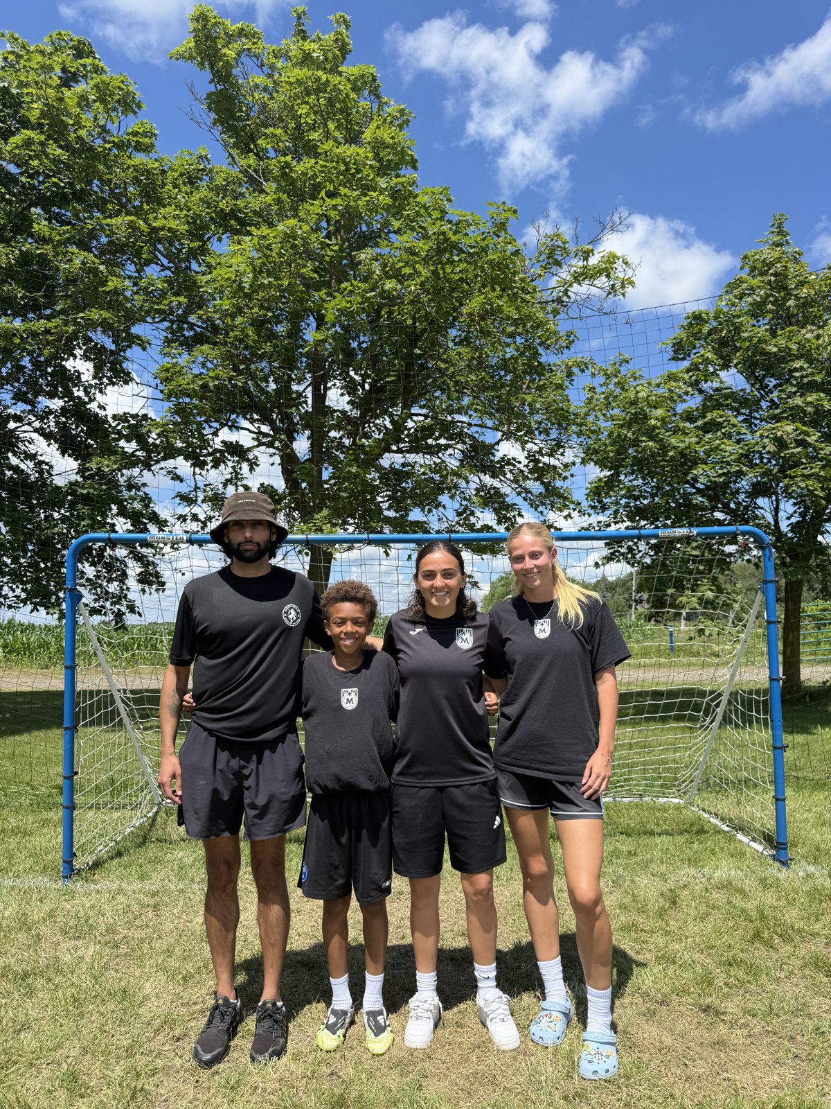Maravilha coaches with a young camper at July 2026 summer camp