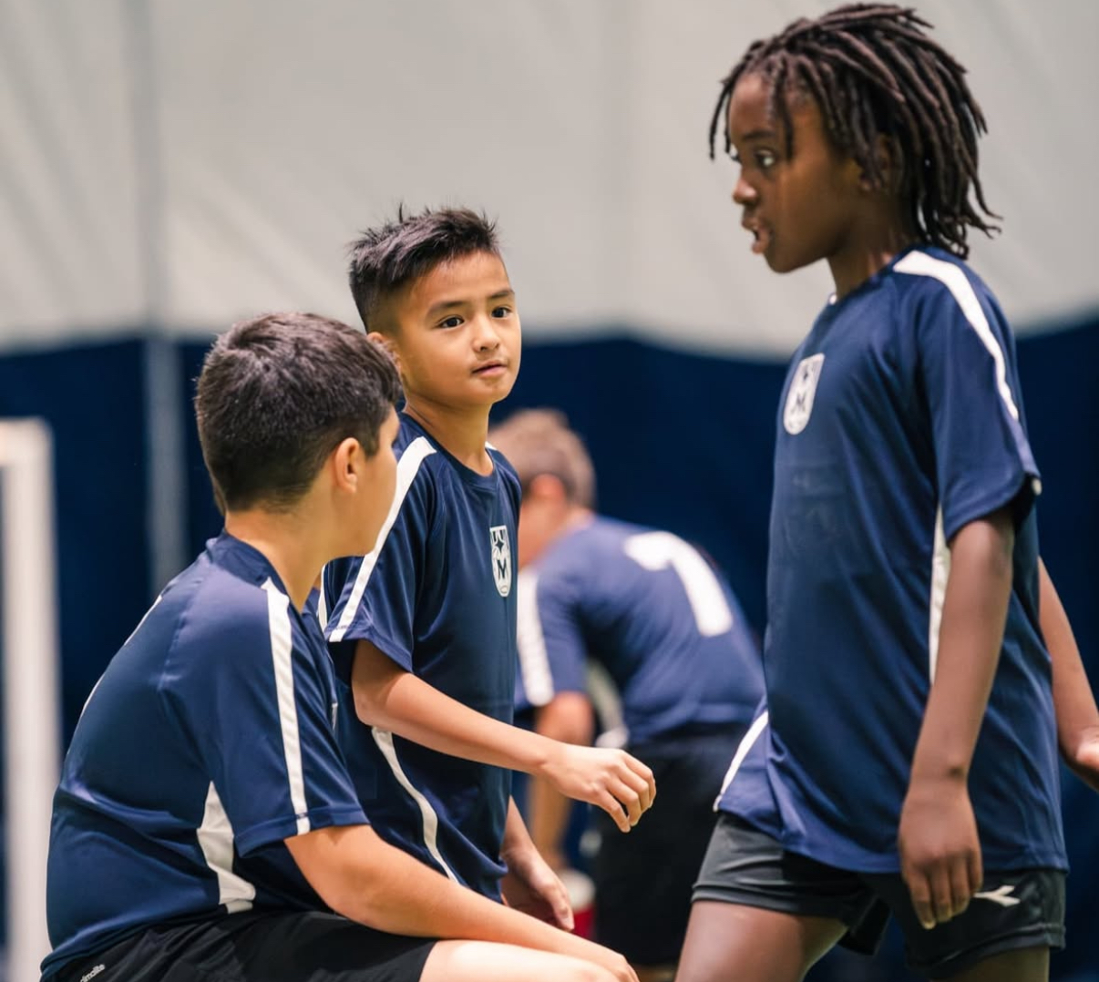 Competitive rep players listening and preparing during indoor training