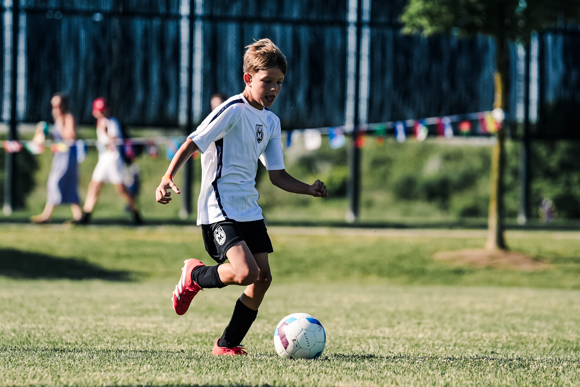 Competitive rep player dribbling during outdoor match play